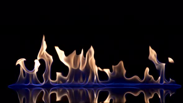 Flash and Fire Streak of Flammable Liquid or Gasoline Against Black Reflective Background