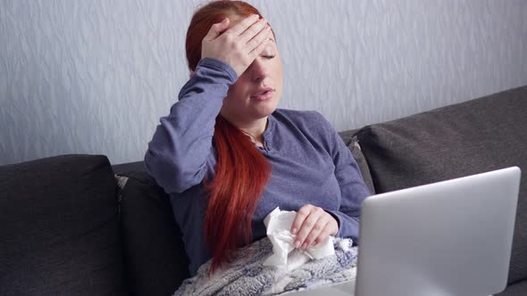 Sick Woman Sneezes Into a Paper Scarf at Home.