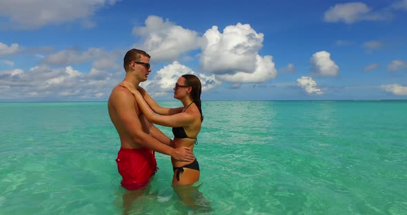 Romantic boy and girl on romantic honeymoon enjoy luxury on beach on paradise white sand background 