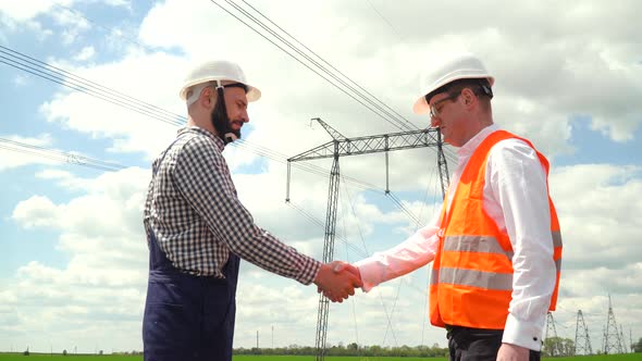 Two Engineers Working Near Transmission Lines