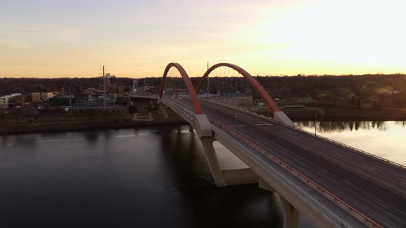 Wide angle aerial approach towards Hastings Bridge, over the Mississippi River, at dusk
