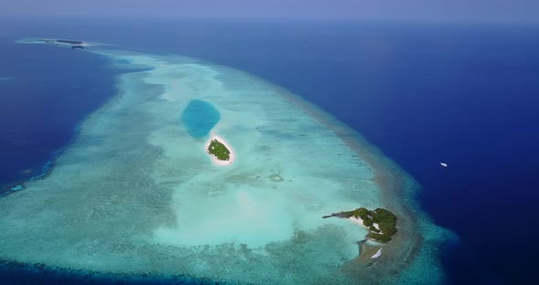 Tropical fly over tourism shot of a white sandy paradise beach and aqua blue water background 