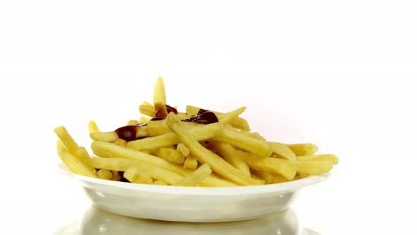 Ketchup Drops on French Fries in Disposable Plastic Plate 360 Rotating