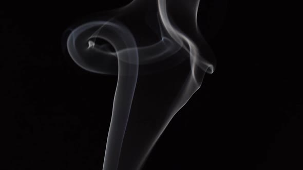 White smoke on black background in slow motion