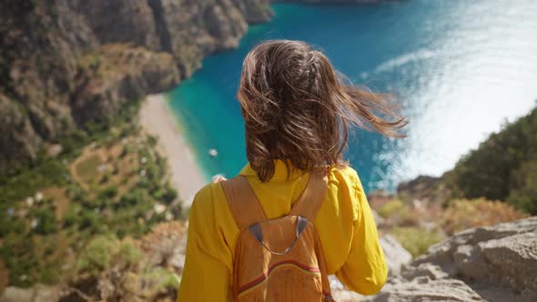 Aerial Top View Woman Traveler with Blowing Hair Enjoying Beautiful View of Butterfly Valley From