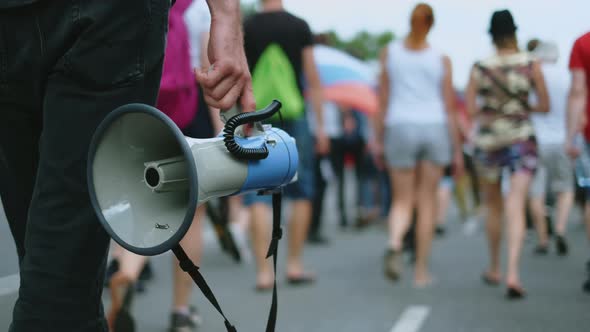 Protester Man Walks with Megaphone in Hands