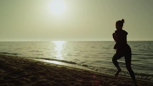 Back View Runner Woman at Summer Sunset