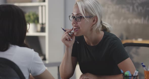 Teacher Explaining To Student in a Classroom