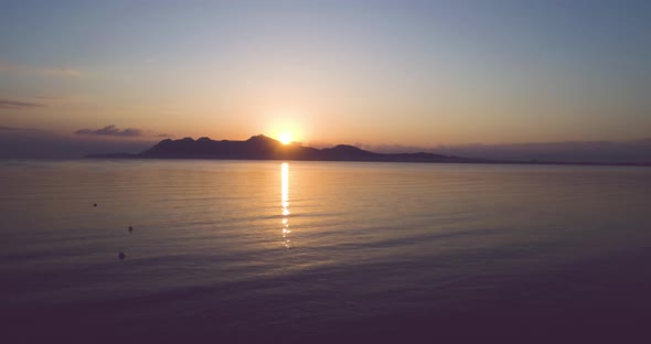 Sunset over island in sea