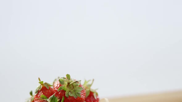 Fresh strawberries in wicker bowl