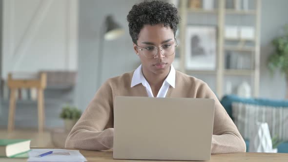 African Girl Leaving Laptop on Table After Work Done