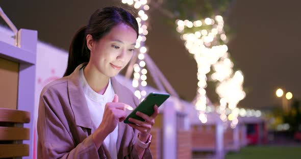 Young business woman work on mobile phone at night