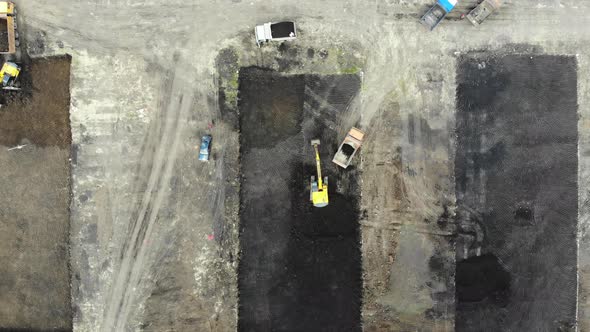 Machines digging pit. Construction process. Pit for building. Construction site from the air.