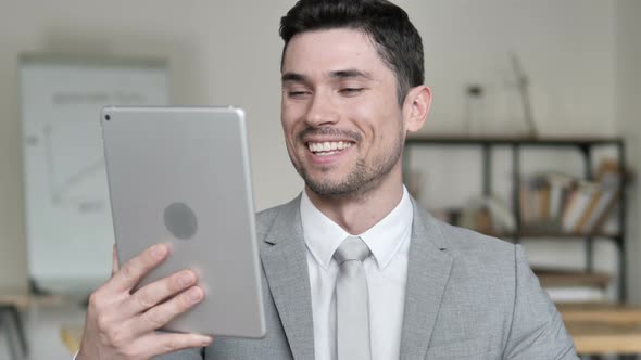 Online Video Chat on Tablet by Businessman