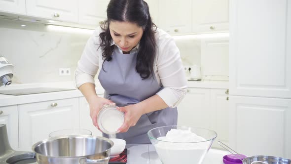 Women Cook Pours Flour From the Jar Into a Bowl on Scale