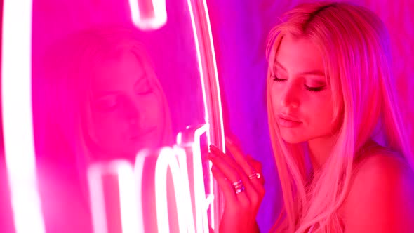 Romantic Portrait of Beautiful Woman with Neon Pink Light in Club Dream and Fantasy About Love
