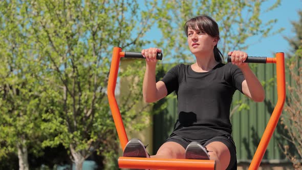 The Girl Goes in for Sports on the Street on a Sunny Day