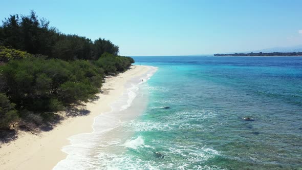 Aerial top down sky of relaxing tourist beach voyage by blue ocean with bright sand background of a 