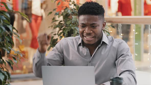Closeup Young Excited Businessman Reads Good News By Email on Laptop Amazed Happy Guy Winner