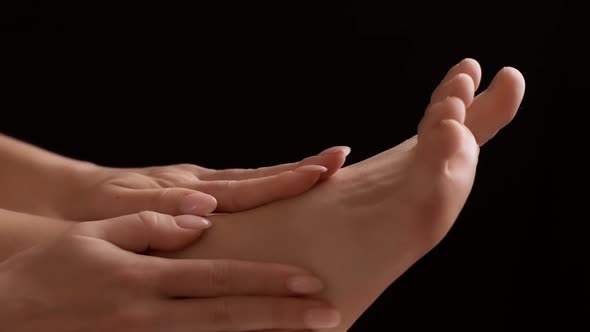 Woman Massaging Her Sprained Foot