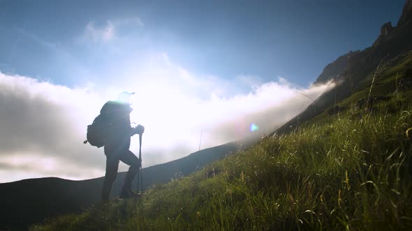 Traveler Caucasian Woman Walks Along the Narrow Ridge of the Peak at Sunset