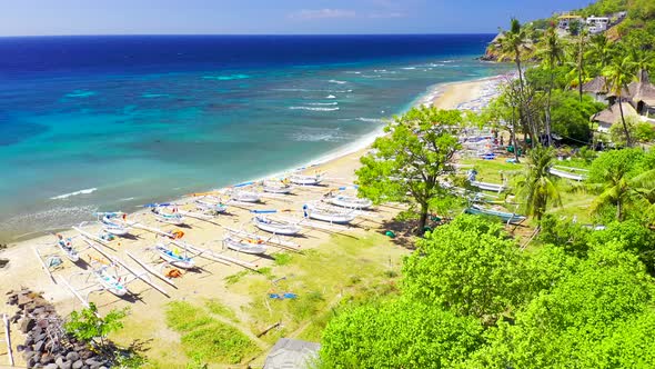 Many White Fisherman Boats on the White Sand Beach and Azure Sea in Amed, Bali, Indonesia. Aerial