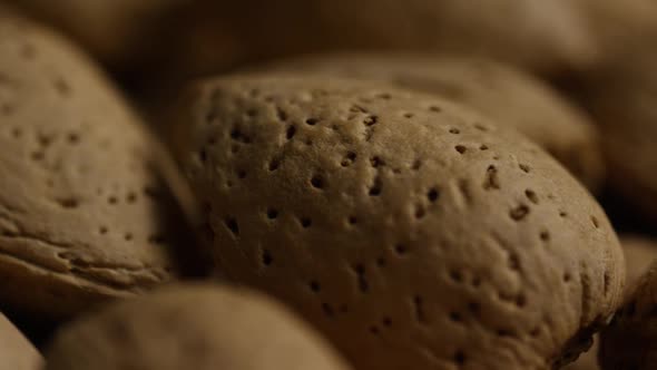 Cinematic, rotating shot of almonds on a white surface 