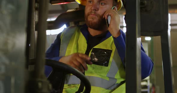 Male worker talking on mobile phone 