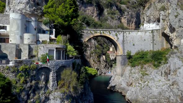 Flythrough of Fiordo di Furore arch bridge leading to the small village inside the fjord, Amalfi coa