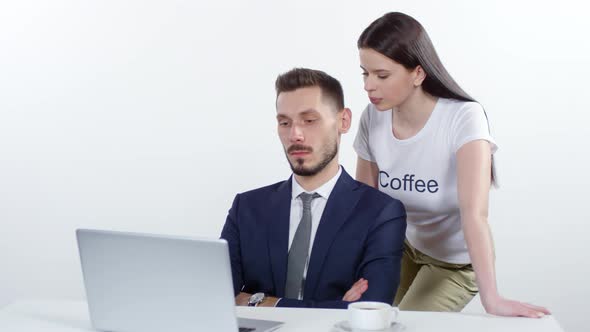 Woman Tempting Businessman to Drink Coffee