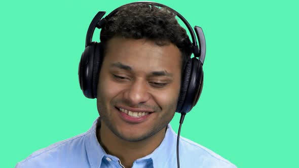 Cheerful Dark-skinned Man Listening Music in Headphones.