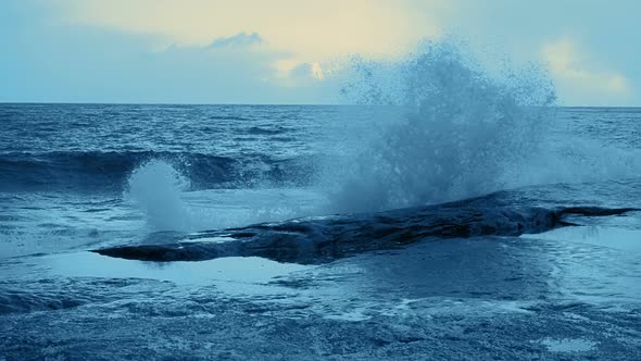 Surf Wave Crashing on Coastal Rocks