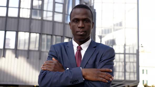 Confident and Seriuos Black Businessman Crossing His Arms Staring at Camera