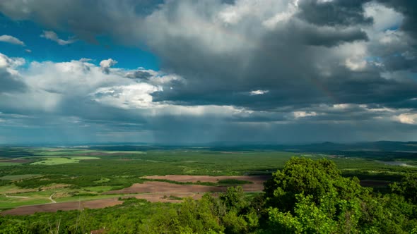 Cloudy Landscape With A Rainbow