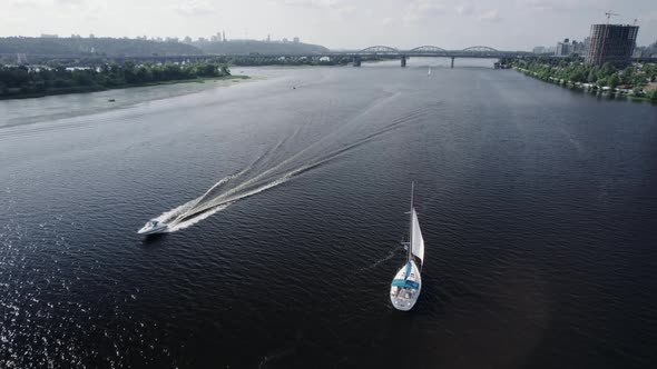 Riding Boats in the River on the Background of a City