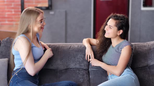 Two Young Female Friend Laughing Talking Having Good Time Together at Home Medium Shot