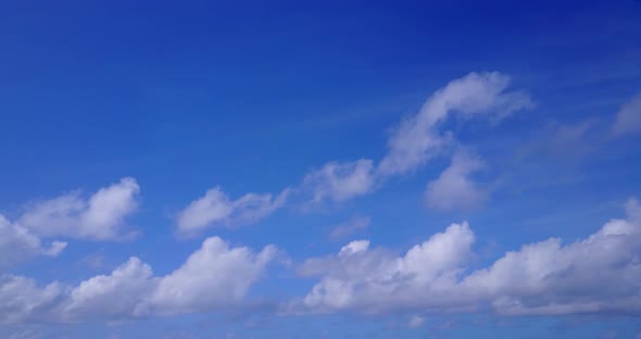 Daytime above tourism shot of a paradise sunny white sand beach and blue ocean background in vibrant