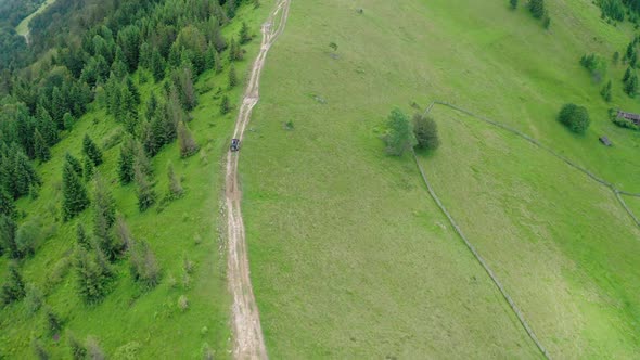 Aerial Drone View of People Traveling By Car with an Open Top in the Mountains