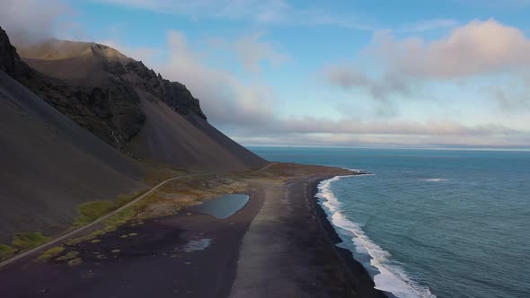 Flying Above a Black Sand Beach Near the Eystrahorn Mountains in Iceland