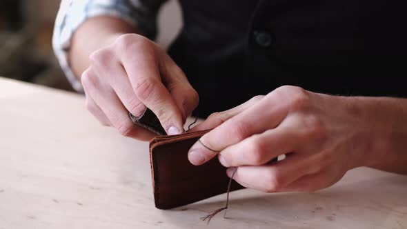 The Tanner Is Stitching a Hand-made Leather Wallet