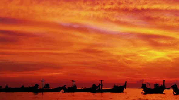 Aerial shot of Koh Tao island, Super sunset at Sairee Beach with many boats floating Thailand