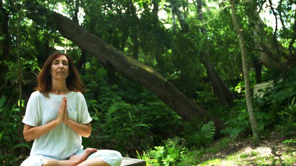 Mature woman performing yoga in the park