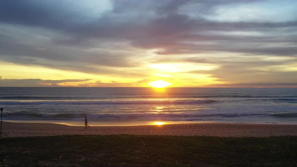 A Man Joking On The Beach At Sunset