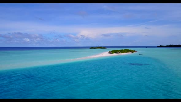 Aerial top down nature of idyllic coastline beach holiday by blue water with white sand background o