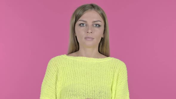 Young Beautiful Girl Looking at Camera Pink Background