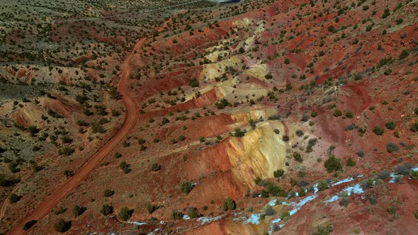 Aerial view over orange and yellow rock formations in vermillion cliffs, utah.