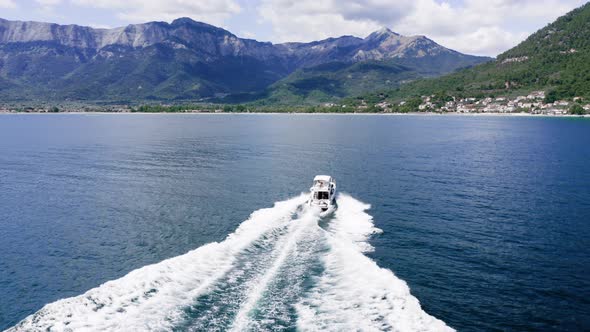 Luxury yacht with family sailing in the sea, drone view, summertime holidays.