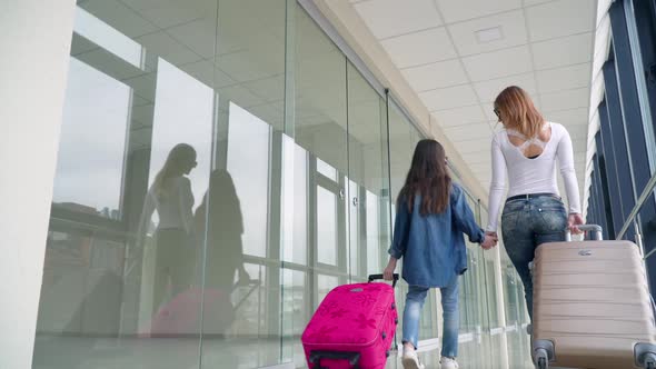 Passengers with Suitcases Walking on the Terminal Airport