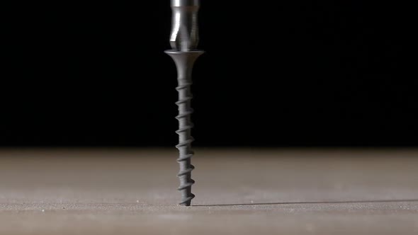 Man Using a Drill and Screwdriver on Wooden Plate, Black, Slow Motion