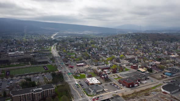 Aerial drone timelapse flying over small, rural downtown of Altoona Pennsylvania in the summer showi